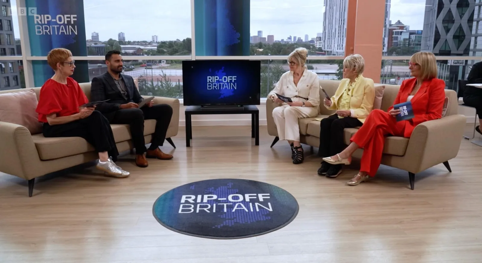 Ax Sharma on the BBC Rip-Off Britain studio set with skyline view